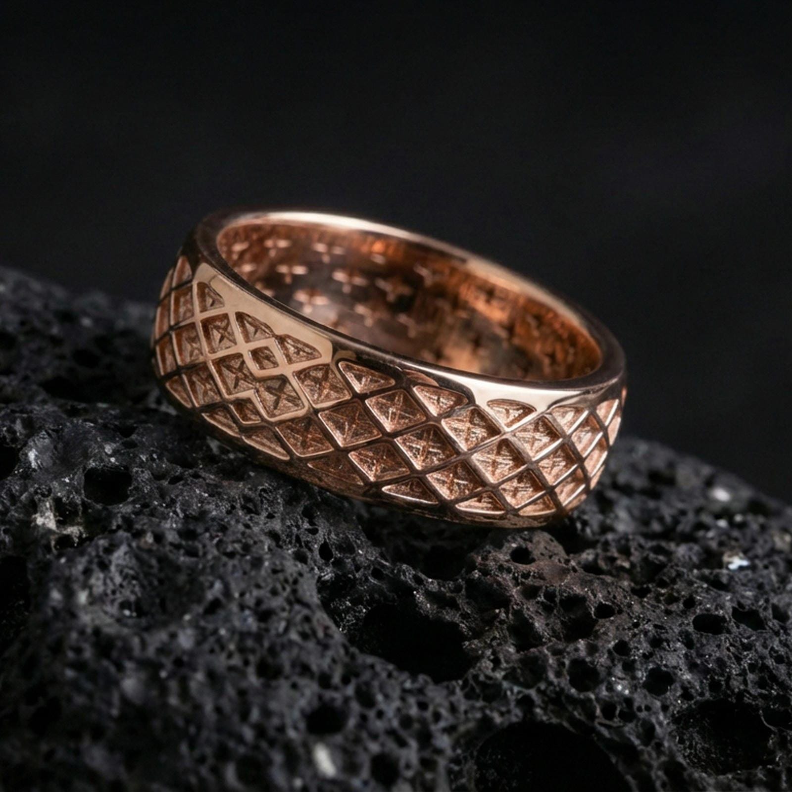 Rose gold plated sterling silver lattice band on volcanic stone, intricate diamond grid texture with refined edges, minimal high-end close-up.