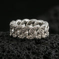 Load image into Gallery viewer, Polished silver Cuban link band ring on black volcanic stone, crisp sculpted chain links with ornate engraved texture, centered close-up studio lighting.
