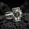 Load image into Gallery viewer, Oxidized sterling silver crucifix Jesus ring on dark volcanic rock, high-relief Christ figure with open cross frame, premium macro product shot.
