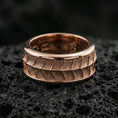 Load image into Gallery viewer, Rose gold plated sterling silver lizard scale spinner ring on volcanic stone, bold textured reptile pattern with deep contrast, minimal high-end close-up.
