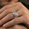 Load image into Gallery viewer, Polished silver elven star fidget spinner ring on finger, crisp knot pattern and central star detail, refined everyday wear close-up.
