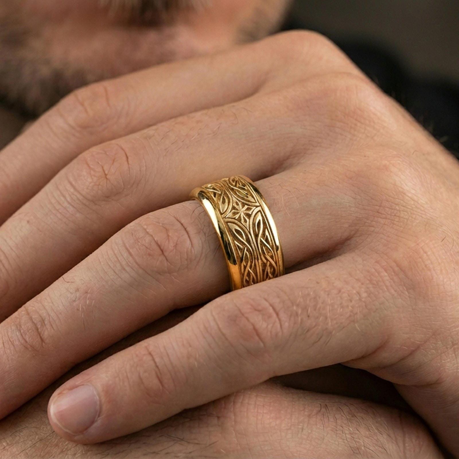 Gold plated elven star spinner band worn on finger, detailed knotwork engraving with star motif on rotating band, premium lifestyle jewelry photo.