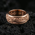 Load image into Gallery viewer, Rose gold plated sterling silver koi fish spinner ring on volcanic stone, sculpted koi and wave relief with deep contrast, minimal high-end close-up.
