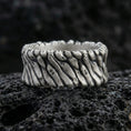 Load image into Gallery viewer, Oxidized sterling silver twisted rope texture band ring on dark volcanic rock, rugged spiral pattern with deep shadowed detail, premium macro product shot.
