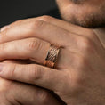 Load image into Gallery viewer, Rose gold plated braided rope band ring worn on finger, sculpted woven texture detail with dotted edges, elegant lifestyle wear shot.
