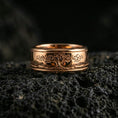 Load image into Gallery viewer, Rose gold plated sterling silver Yggdrasil spinner ring on volcanic stone, sculpted tree of life engraving with deep contrast, minimal high-end close-up.
