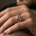 Load image into Gallery viewer, Rose gold plated jaguar spinner ring worn on finger, sculpted big cat relief detail on rotating center, elegant lifestyle wear shot.
