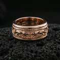 Load image into Gallery viewer, Rose gold plated sterling silver jaguar spinner ring on volcanic stone, sculpted big cat relief with deep contrast and smooth edges, minimal high-end close-up.
