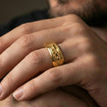 Load image into Gallery viewer, Gold plated jaguar spinner band worn on finger, detailed big cat engraving on rotating band, premium lifestyle jewelry photo.
