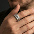Load image into Gallery viewer, Polished silver Moses fidget spinner ring on finger, crisp portrait relief and ornamental side detail, refined everyday wear close-up.
