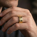 Load image into Gallery viewer, Gold plated mountain range band worn on finger, detailed alpine skyline engraving, premium lifestyle jewelry photo.
