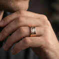 Load image into Gallery viewer, Rose gold plated mountain landscape band ring worn on finger, engraved peak skyline with rugged detail, elegant lifestyle wear shot.
