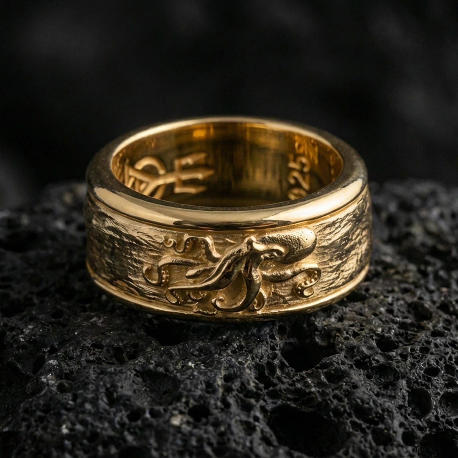 Gold plated octopus spinner band ring on volcanic rock, detailed octopus motif on rotating band with marine texture, luxury jewelry product photography.