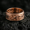 Load image into Gallery viewer, Rose gold plated sterling silver octopus spinner ring on volcanic stone, sculpted octopus relief with deep contrast and clean borders, minimal high-end close-up.
