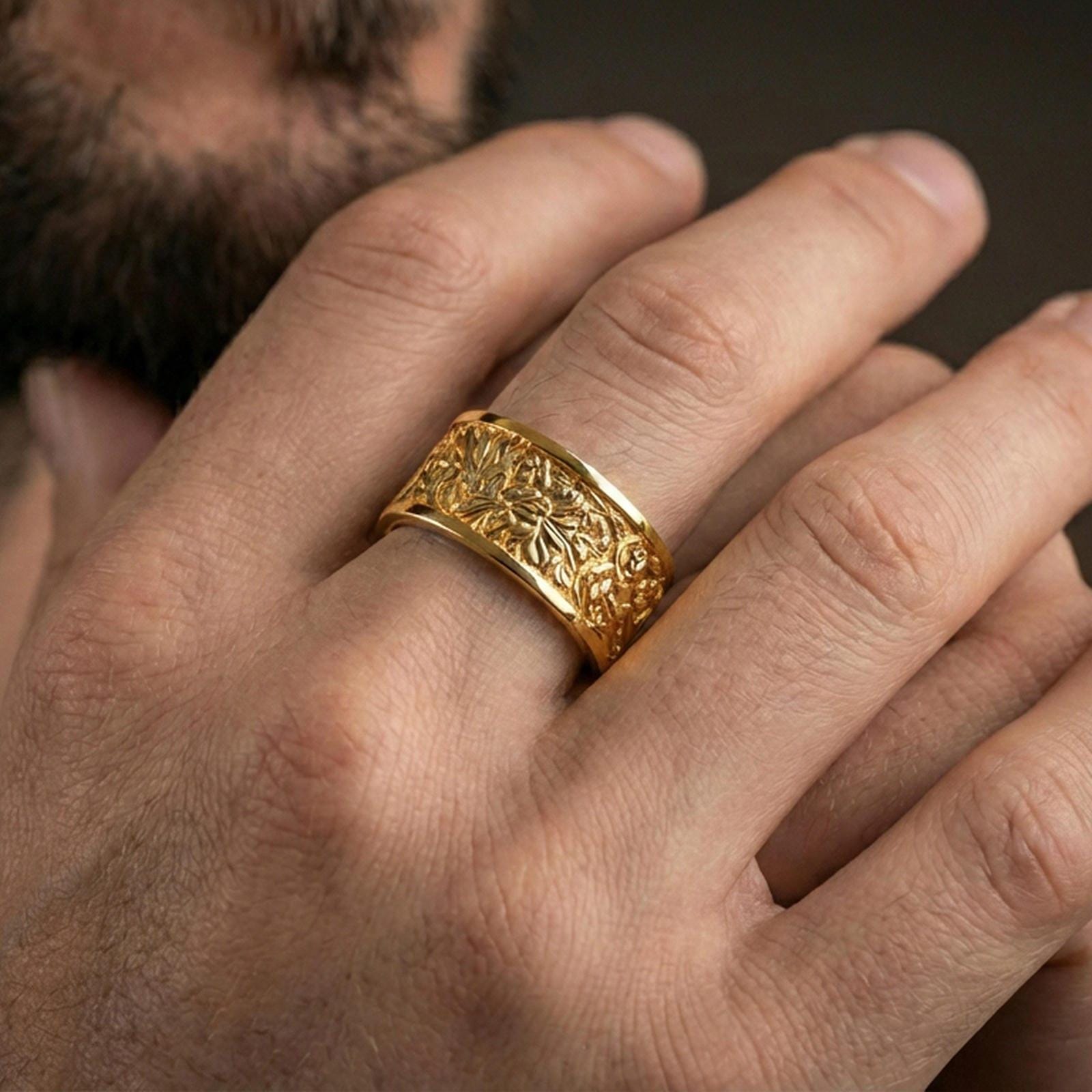 Gold plated jungle wildlife band worn on finger, detailed tropical foliage relief with wildlife engraving, premium lifestyle jewelry photo.
