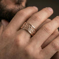 Load image into Gallery viewer, Rose gold plated jungle scene band ring worn on finger, sculpted foliage and wildlife relief detail, elegant lifestyle wear shot.
