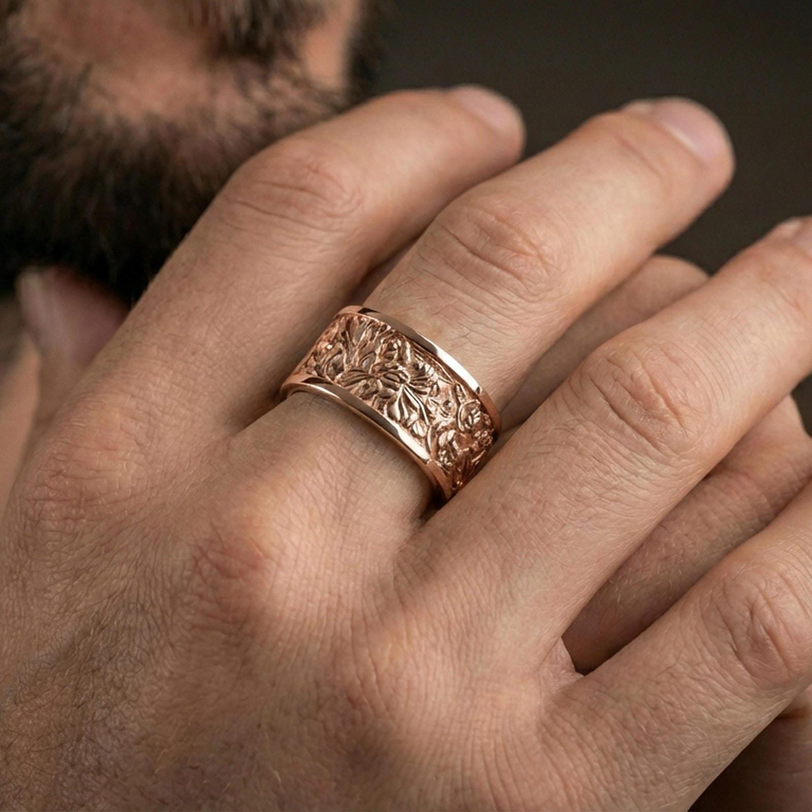Rose gold plated jungle scene band ring worn on finger, sculpted foliage and wildlife relief detail, elegant lifestyle wear shot.