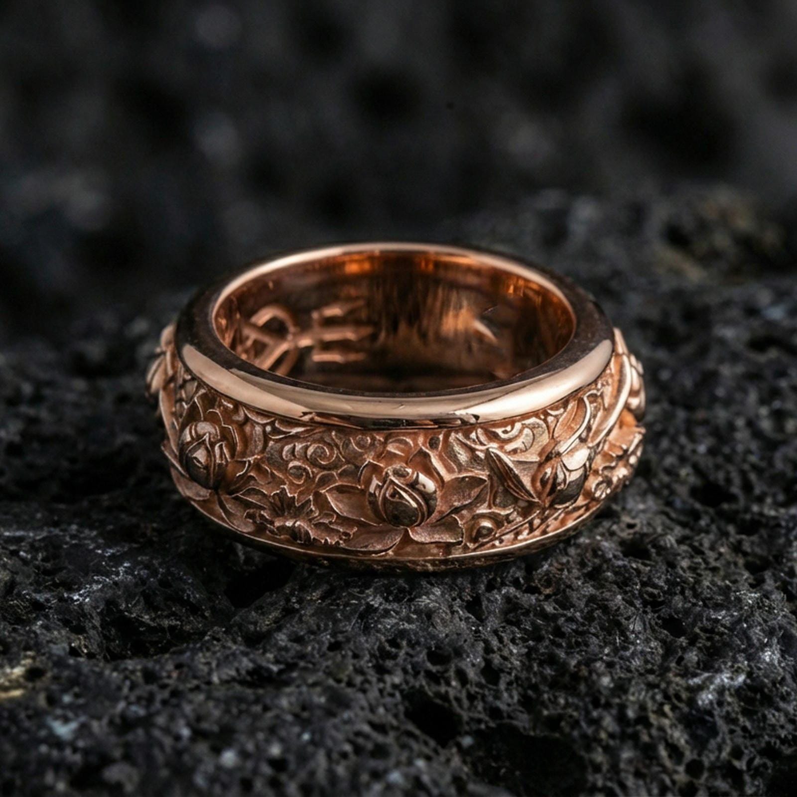 Rose gold plated sterling silver lotus spinner ring on volcanic stone, sculpted lotus blossoms with deep contrast and clean borders, minimal high-end close-up.