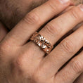 Load image into Gallery viewer, Rose gold plated Moses spinner ring worn on finger, sculpted Renaissance portrait relief detail, elegant lifestyle wear shot.
