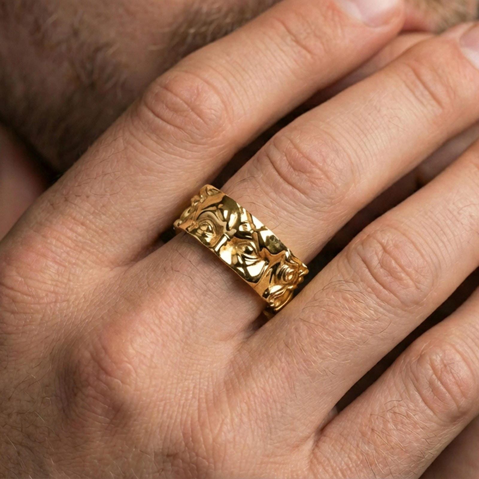 Gold plated Michelangelo Moses spinner band worn on finger, detailed portrait relief on rotating band, premium lifestyle jewelry photo.