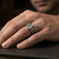 Load image into Gallery viewer, Oxidized sterling silver Saint Jude signet ring worn on finger, saint portrait relief with “God Bless” and “Save Us” engraving, natural lifestyle hand shot with shallow depth of field.

