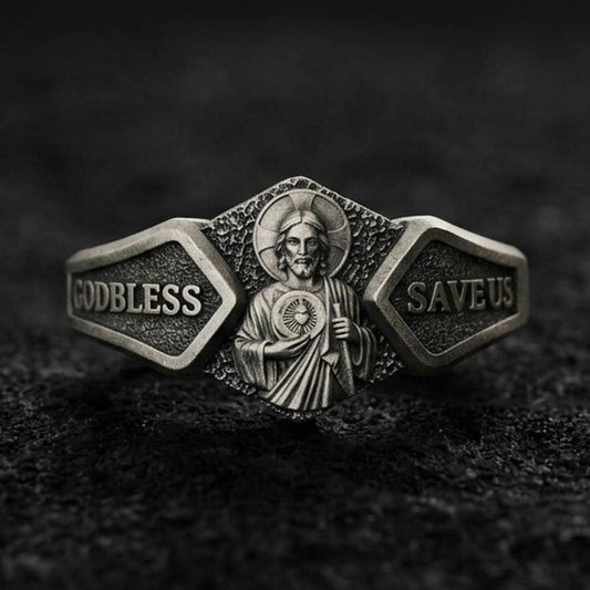 Oxidized sterling silver Saint Jude signet ring on dark volcanic rock, detailed halo portrait relief with “God Bless” and “Save Us” panels, premium macro product shot.