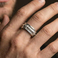 Load image into Gallery viewer, Polished silver arrow fidget spinner ring on finger, crisp arrowhead and wrapped shaft detail, refined everyday wear close-up.
