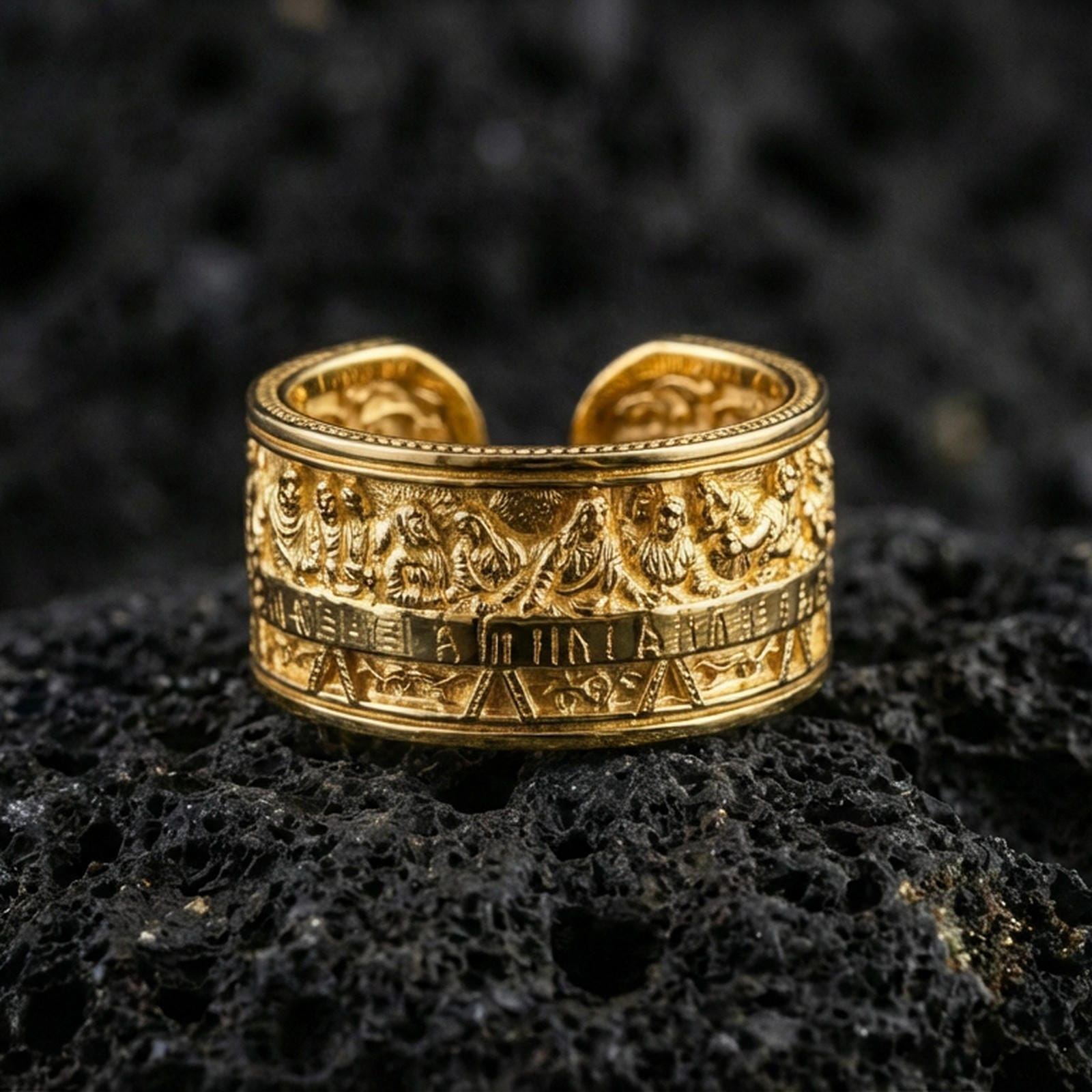 Gold plated Last Supper engraved band ring on volcanic rock, detailed apostle scene relief with architectural border accents, luxury jewelry product photography.