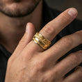 Load image into Gallery viewer, Gold plated Last Supper engraved band worn on finger, detailed apostle scene relief with border accents, premium lifestyle jewelry photo.
