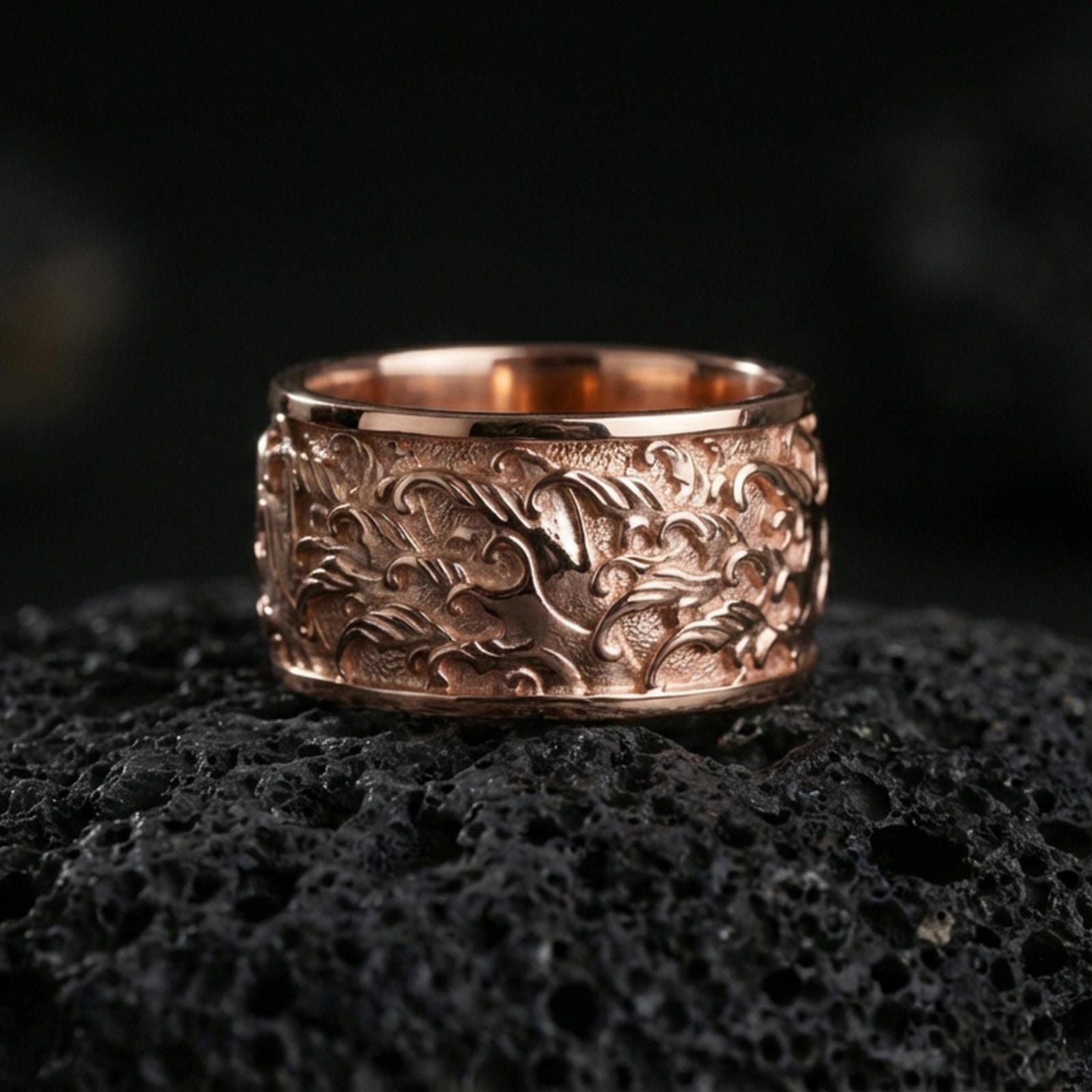 Rose gold plated sterling silver flame swirl band on volcanic stone, sculpted fire relief with strong contrast and clean borders, minimal high-end close-up.