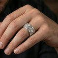Load image into Gallery viewer, Polished silver lion crest band ring on finger, crisp lion medallion relief and geometric cross detail, refined everyday wear close-up.
