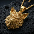 Load image into Gallery viewer, Gold plated wolf head pendant with ornate carved fur pattern, pointed ears, and striking predator design showcased on black volcanic rock in a refined macro jewelry image
