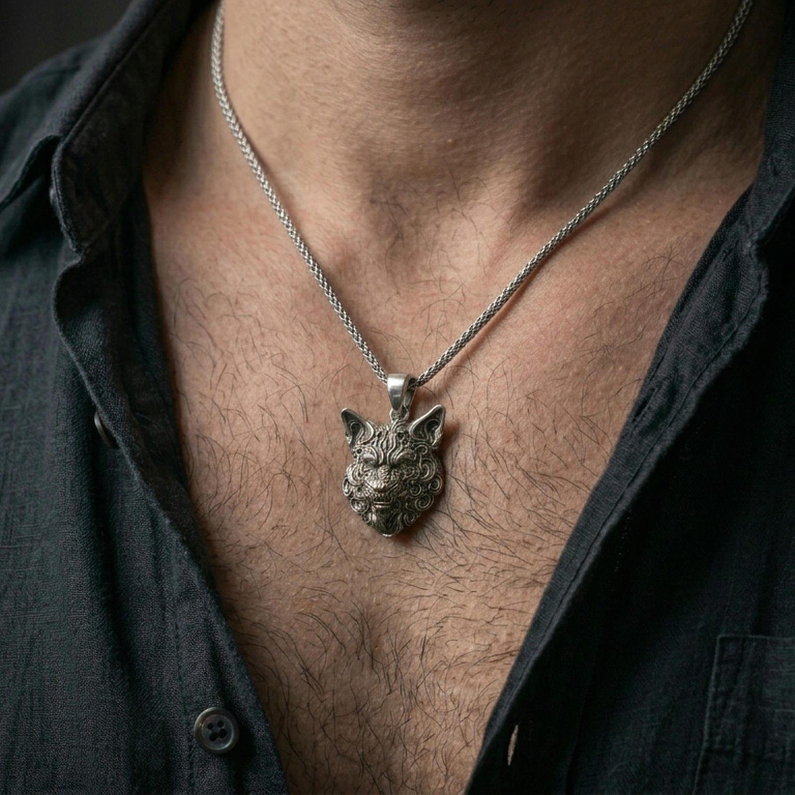 Oxidized wolf head pendant worn on the neck in a lifestyle jewelry shot, styled against the chest for a bold and nature-inspired statement look