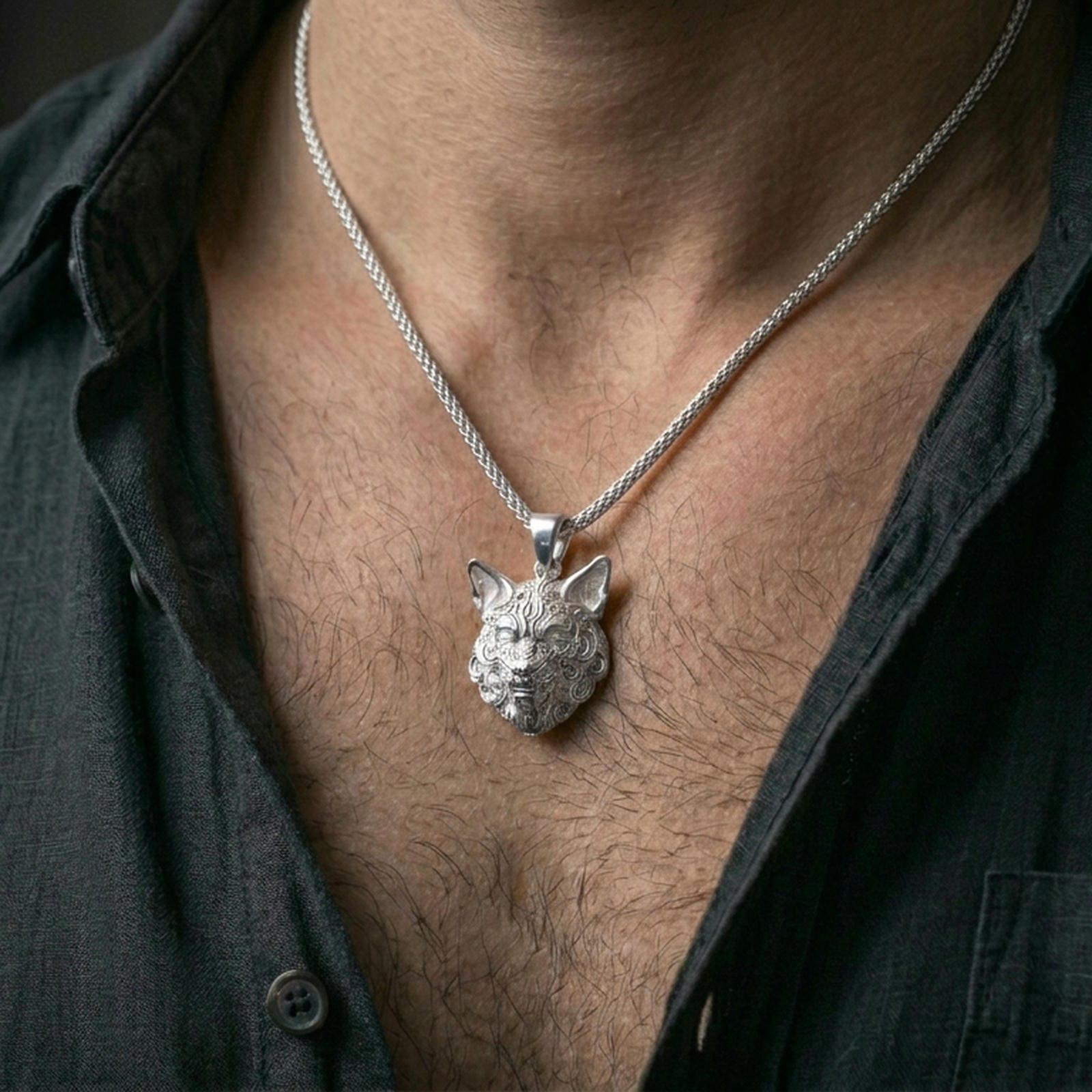 Polished silver wolf necklace worn on the neck in a close lifestyle frame, highlighting the sculpted animal face and intricate fur detailing