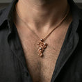 Load image into Gallery viewer, Rose gold plated snake pendant with wrapped serpent silhouette, scale relief, and apple detail worn on the neck in a refined lifestyle shot with a warm and distinctive presentation
