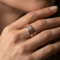 Load image into Gallery viewer, Rose gold plated geometric grid band worn on finger, refined warm tone with crisp patterned detail, elegant lifestyle close-up.
