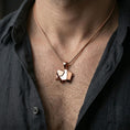 Load image into Gallery viewer, Rose gold plated geometric elephant necklace with sleek folded elephant form worn on the neck in a refined lifestyle shot with a warm and elegant presentation
