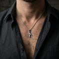Load image into Gallery viewer, Oxidized origami parrot pendant worn on the neck in a lifestyle jewelry shot, styled against the chest for a bold and modern statement look
