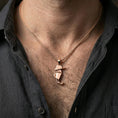 Load image into Gallery viewer, Rose gold plated geometric seahorse necklace with minimalist folded shape worn on the neck in a refined lifestyle shot with a warm and elegant presentation
