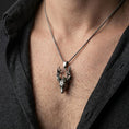 Load image into Gallery viewer, Oxidized stag pendant with detailed deer head and branching antlers worn on the neck in a lifestyle jewelry shot, styled against the chest for a bold and nature-inspired look
