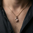 Load image into Gallery viewer, Rose gold plated geometric bunny necklace with sleek folded rabbit form worn on the neck in a refined lifestyle shot with a warm and elegant presentation
