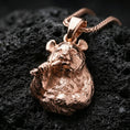 Load image into Gallery viewer, Rose gold plated panda necklace with sculpted bear form, fine fur detailing, and playful bamboo accent resting on volcanic rock in an elegant close-up product presentation
