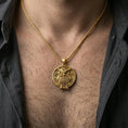 Load image into Gallery viewer, Gold plated owl pendant with intricate feather texture and round symbolic silhouette worn on the neck in a premium lifestyle composition with elegant bird-inspired jewelry styling
