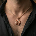 Load image into Gallery viewer, Rose gold plated ram necklace with detailed zodiac animal relief, curved horn design, and elegant Aries symbolism worn on the neck in a refined lifestyle shot with a warm and sophisticated presentation
