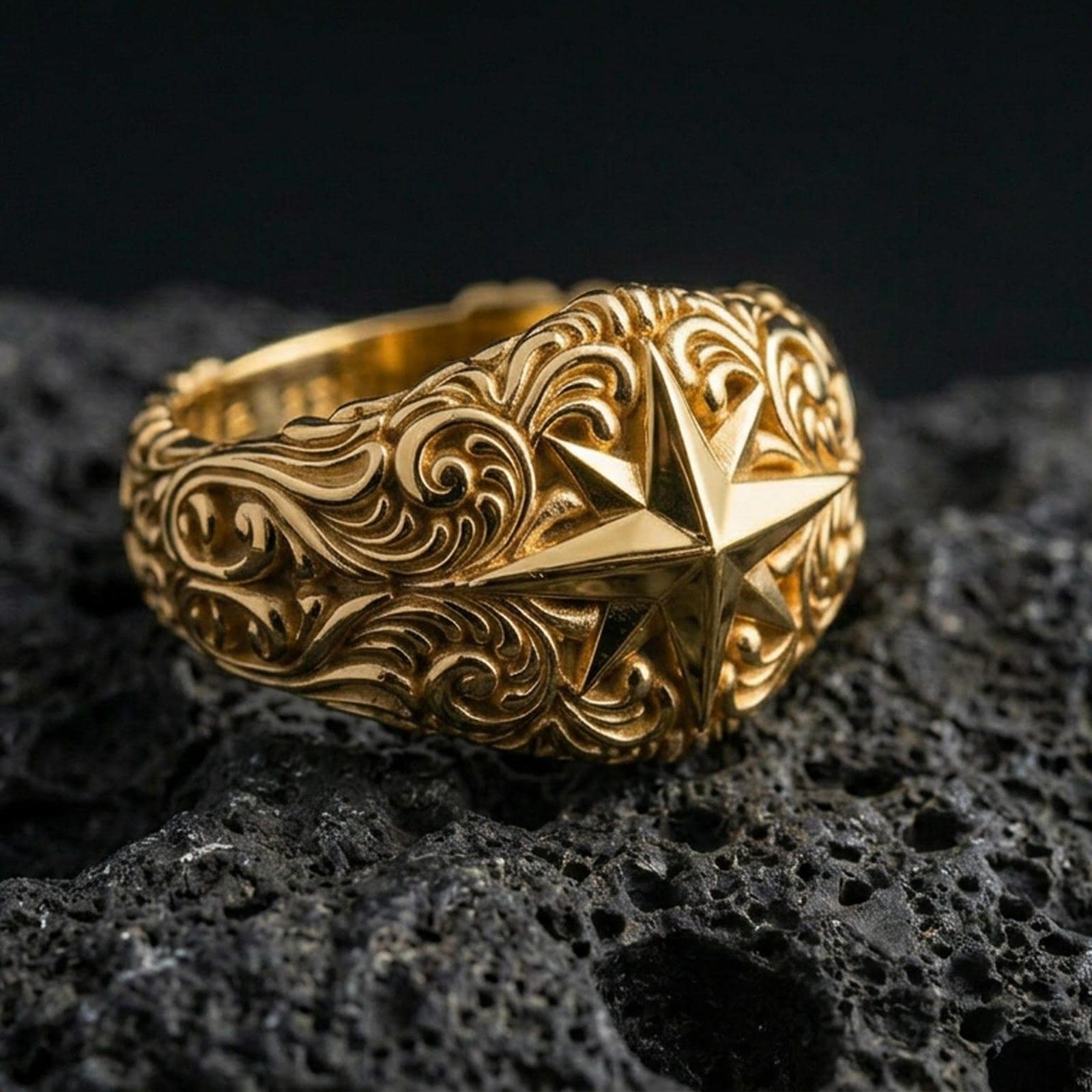 Gold plated North Star compass ring on black volcanic stone, warm reflective finish emphasizing the hand-carved star facets and ornamental scrolls.