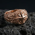 Load image into Gallery viewer, Rose gold plated North Star ring on volcanic rock, soft warm tone highlighting the compass star centerpiece and sculpted vintage scroll pattern.
