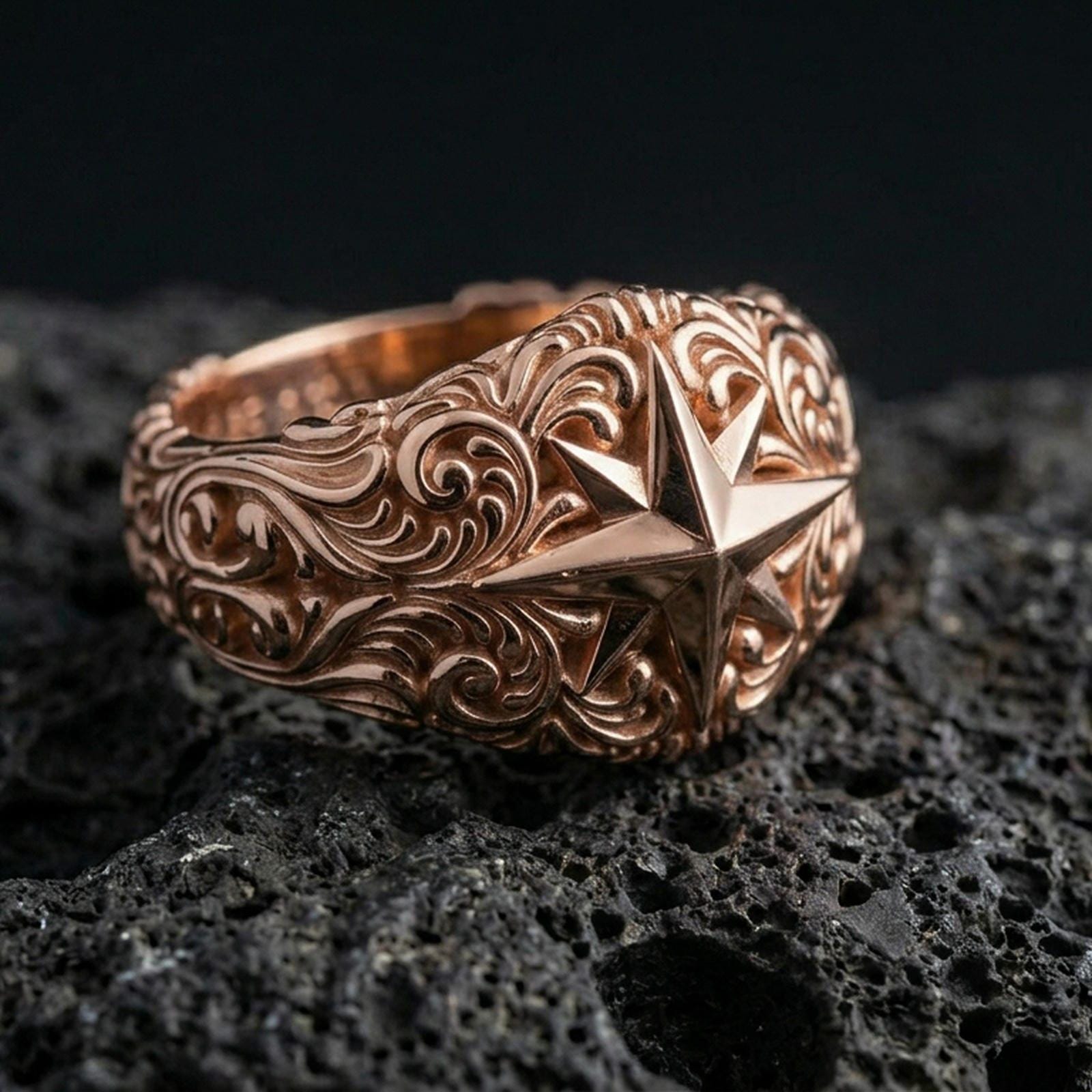 Rose gold plated North Star ring on volcanic rock, soft warm tone highlighting the compass star centerpiece and sculpted vintage scroll pattern.