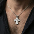 Load image into Gallery viewer, Holy Trinity cross pendant on a model’s neck, close-up view of the front side with IHS and sacramental symbolism.
