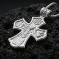 Load image into Gallery viewer, 925 sterling silver Holy Trinity cross pendant on volcanic rock with a clean polished shine highlighting the carvier edges.
