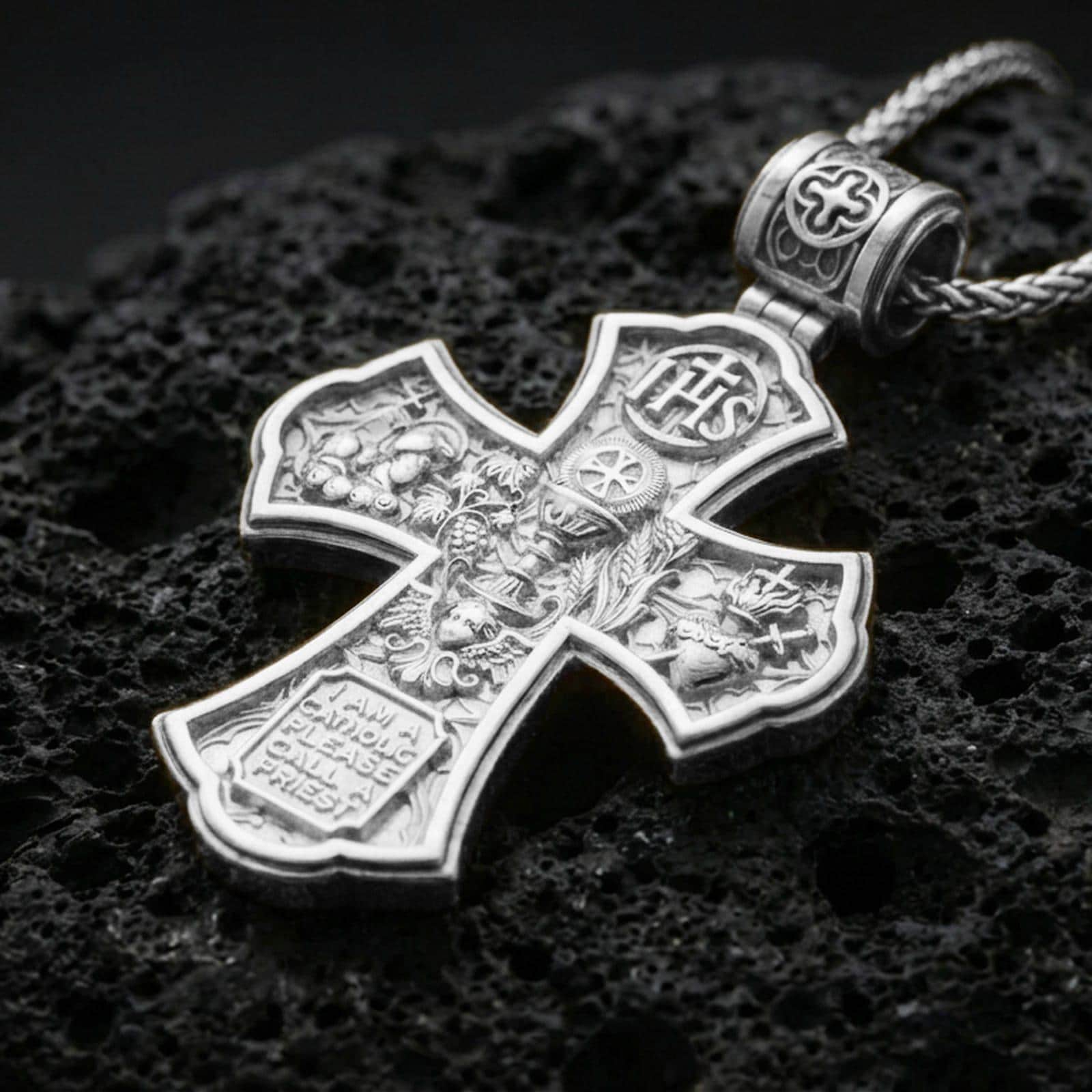 925 sterling silver Holy Trinity cross pendant on volcanic rock with a clean polished shine highlighting the carvier edges.